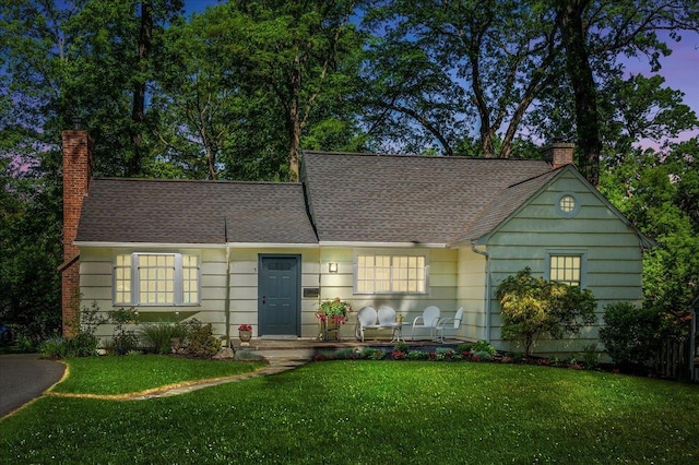 3 Reigate Pl, Suffern, NY 10901 - view of front facade featuring a chimney, a front lawn, and roof with shingles