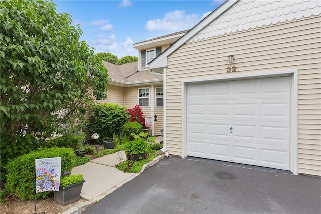 32 Blueberry Cmn, Riverhead, NY 11901 - garage with asphalt driveway