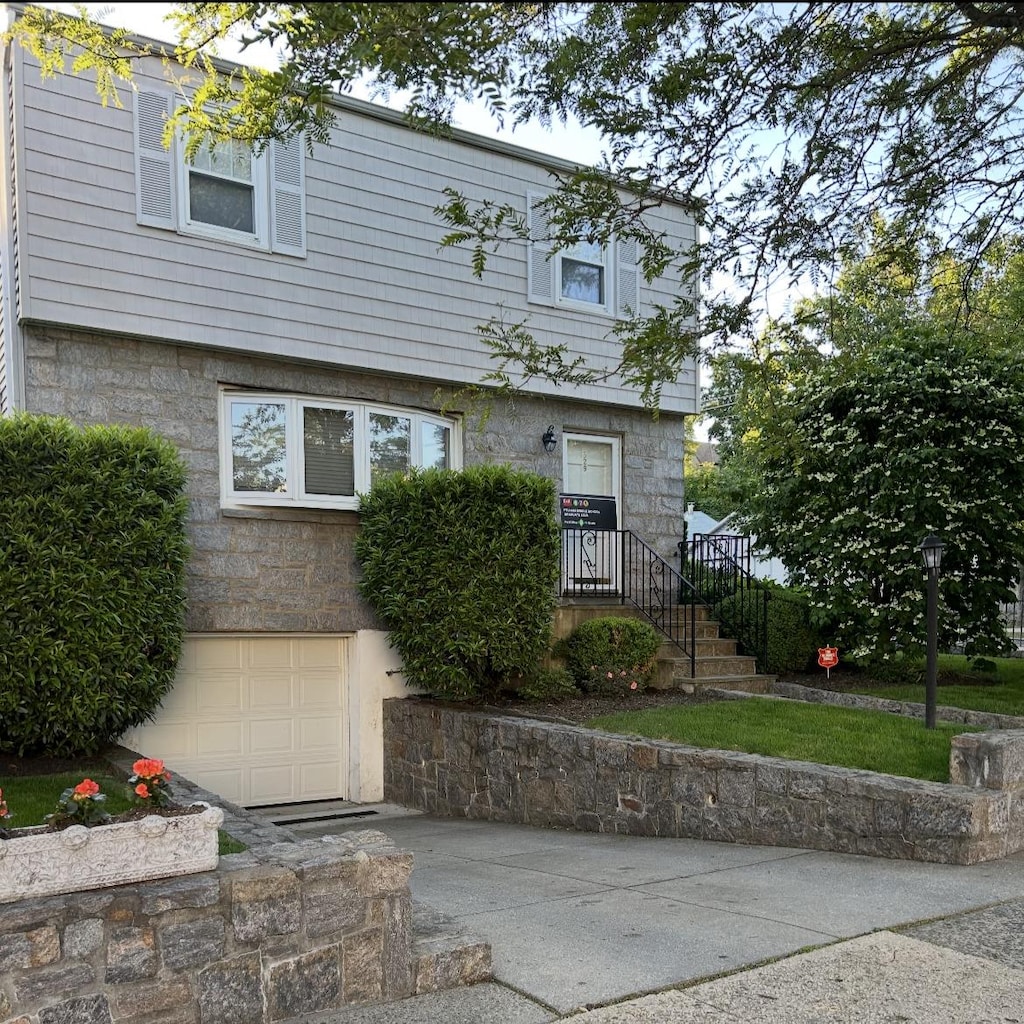 529 Fourth Ave, Pelham, NY 10803 - view of front of house with an attached garage and stone siding