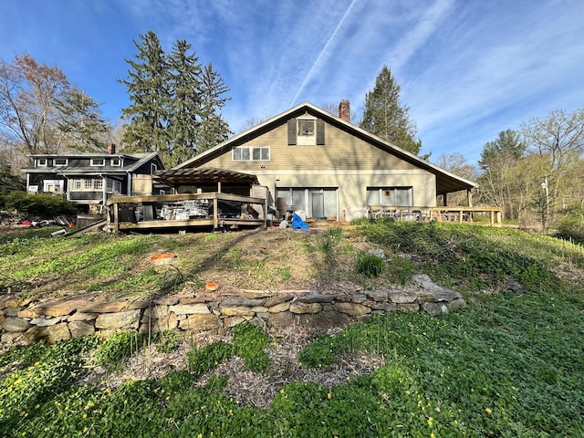 210 Seven Bridges Rd Unit A, Mount Kisco, NY 10549 - rear view of property with a wooden deck and a chimney
