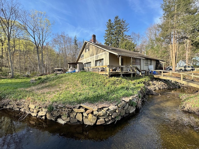 210 Seven Bridges Rd Unit A, Mount Kisco, NY 10549 - rear view of property featuring a chimney and a wooden deck