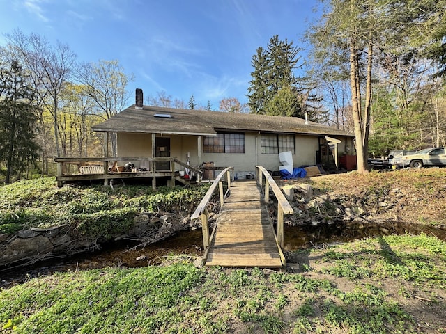 210 Seven Bridges Rd Unit A, Mount Kisco, NY 10549 - rear view of house with a chimney and roof with shingles