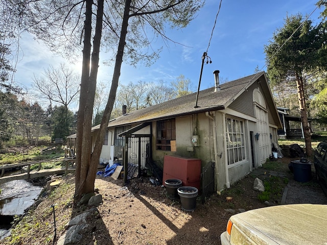 210 Seven Bridges Rd Unit A, Mount Kisco, NY 10549 - view of property exterior featuring roof with shingles and stucco siding