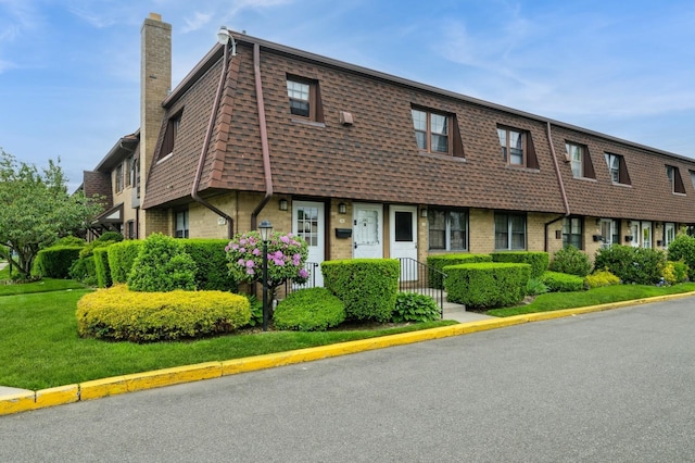 240 Mariners Way, Copiague, NY 11726 - view of property with a chimney, brick siding, and mansard roof