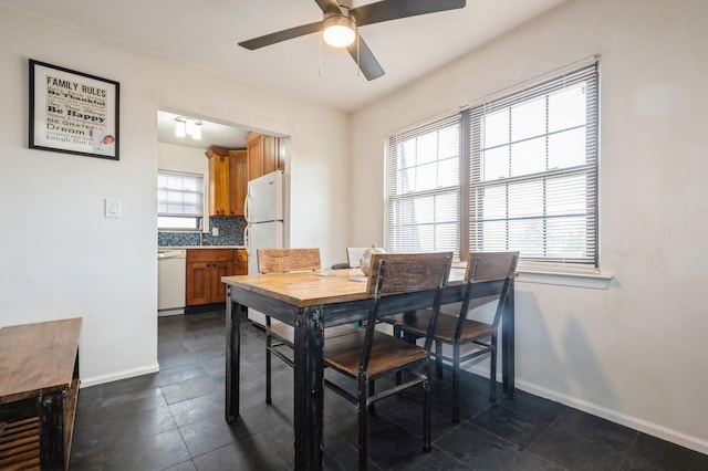 240 Mariners Way, Copiague, NY 11726 - dining room with a ceiling fan, baseboards, and dark tile patterned floors