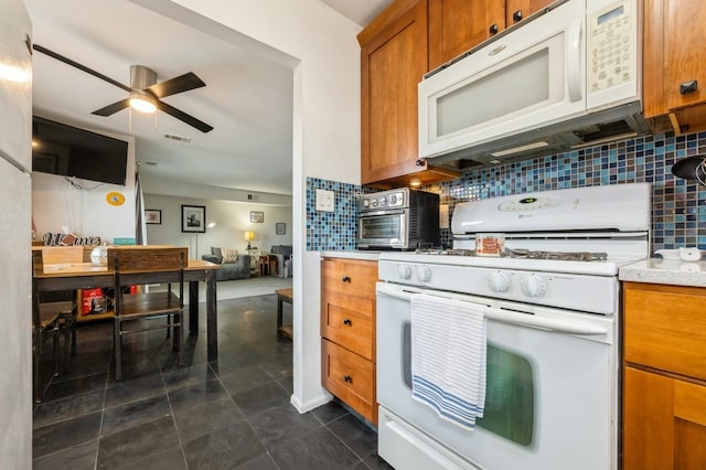 240 Mariners Way, Copiague, NY 11726 - kitchen with white appliances, brown cabinetry, decorative backsplash, ceiling fan, and dark tile patterned flooring
