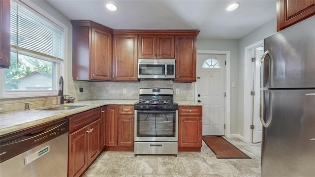 105 Pilgrim Pl, Valley Stream, NY 11580 - kitchen with stainless steel appliances, a sink, healthy amount of natural light, decorative backsplash, and recessed lighting