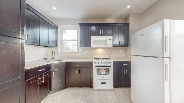 105 Pilgrim Pl, Valley Stream, NY 11580 - kitchen with white appliances, a sink, light countertops, tasteful backsplash, and recessed lighting