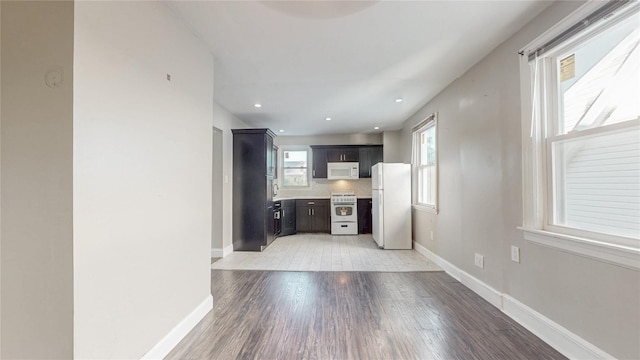 105 Pilgrim Pl, Valley Stream, NY 11580 - kitchen with white appliances, light wood-style flooring, light countertops, baseboards, and recessed lighting