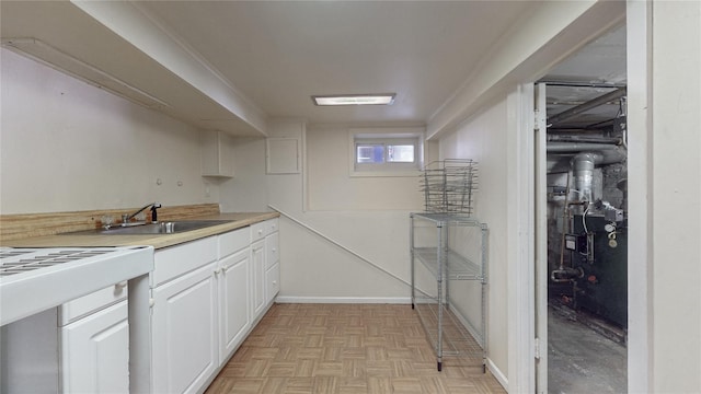 105 Pilgrim Pl, Valley Stream, NY 11580 - kitchen with a sink, white cabinetry, and light countertops