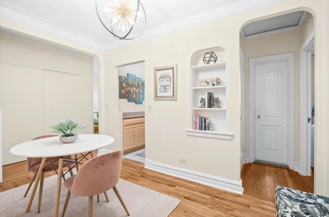 1 Bronxville Rd Unit 6M, Bronxville, NY 10708 - dining room with light wood-style flooring, crown molding, baseboards, and arched walkways
