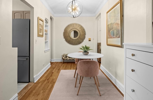 1 Bronxville Rd Unit 6M, Bronxville, NY 10708 - dining area featuring crown molding, baseboards, light wood-type flooring, built in features, and a chandelier