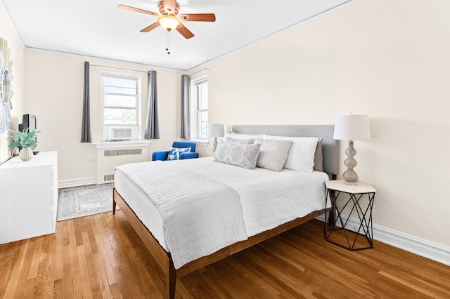 1 Bronxville Rd Unit 6M, Bronxville, NY 10708 - bedroom with radiator heating unit, baseboards, wood finished floors, and a ceiling fan
