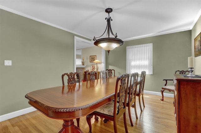 61 Maple Dr, New Hyde Park, NY 11040 - dining area featuring crown molding, baseboards, and light wood-style flooring