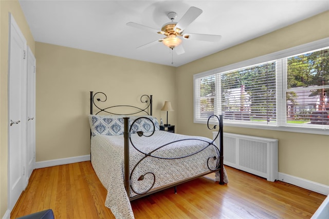 61 Maple Dr, New Hyde Park, NY 11040 - bedroom with radiator, baseboards, wood finished floors, and ceiling fan