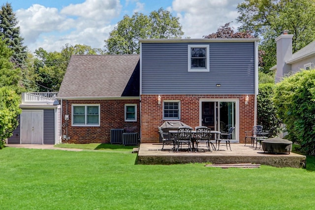 61 Maple Dr, New Hyde Park, NY 11040 - back of property featuring brick siding, a patio area, a yard, and central AC