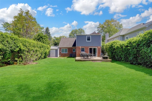 61 Maple Dr, New Hyde Park, NY 11040 - back of property with brick siding, a patio area, and a yard