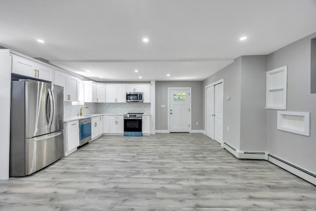 63 Ridgeway Ave, Setauket, NY 11733 - kitchen featuring stainless steel appliances, light wood-style flooring, white cabinets, light countertops, and recessed lighting