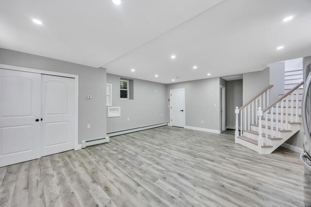 63 Ridgeway Ave, Setauket, NY 11733 - unfurnished living room featuring light wood-style flooring, recessed lighting, baseboards, a baseboard radiator, and stairway