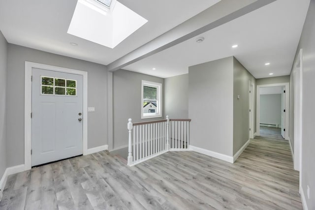 63 Ridgeway Ave, Setauket, NY 11733 - entryway with baseboards, light wood-type flooring, a skylight, recessed lighting, and a baseboard heating unit