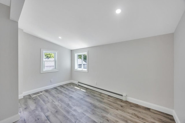 63 Ridgeway Ave, Setauket, NY 11733 - unfurnished room with a baseboard radiator, vaulted ceiling, wood finished floors, baseboards, and recessed lighting