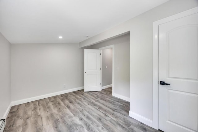 63 Ridgeway Ave, Setauket, NY 11733 - basement with wood finished floors, recessed lighting, baseboards, and a baseboard heating unit