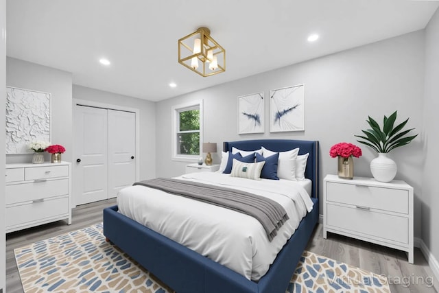 63 Ridgeway Ave, Setauket, NY 11733 - bedroom featuring wood finished floors, recessed lighting, a closet, a chandelier, and baseboards