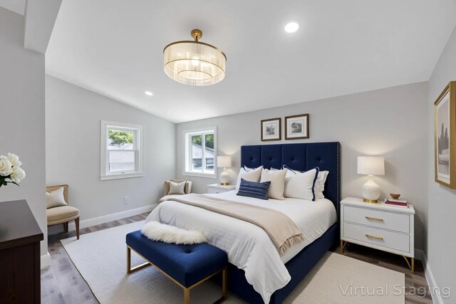 63 Ridgeway Ave, Setauket, NY 11733 - bedroom featuring vaulted ceiling, baseboards, wood finished floors, and recessed lighting