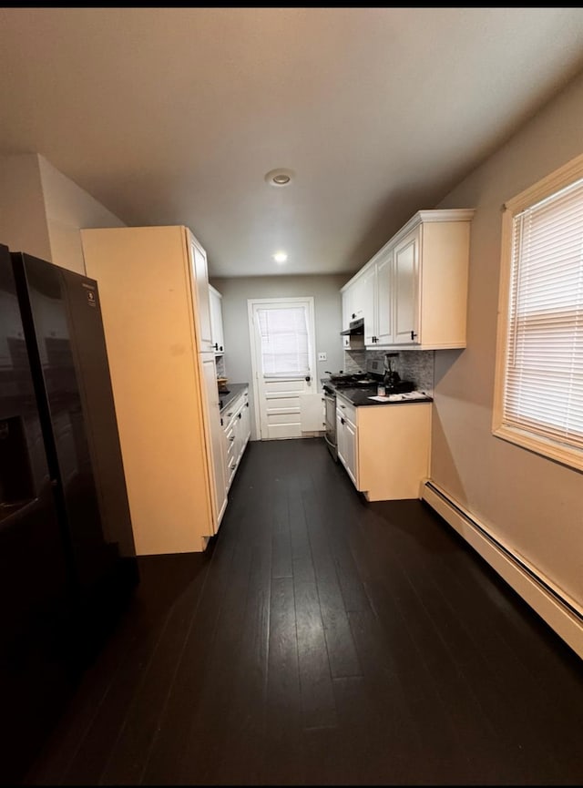 146 Grand Blvd, Brentwood, NY 11717 - kitchen with a baseboard heating unit, dark wood finished floors, white cabinetry, recessed lighting, and backsplash