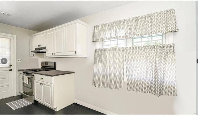 146 Grand Blvd, Brentwood, NY 11717 - kitchen featuring stainless steel gas range, under cabinet range hood, white cabinets, and healthy amount of natural light