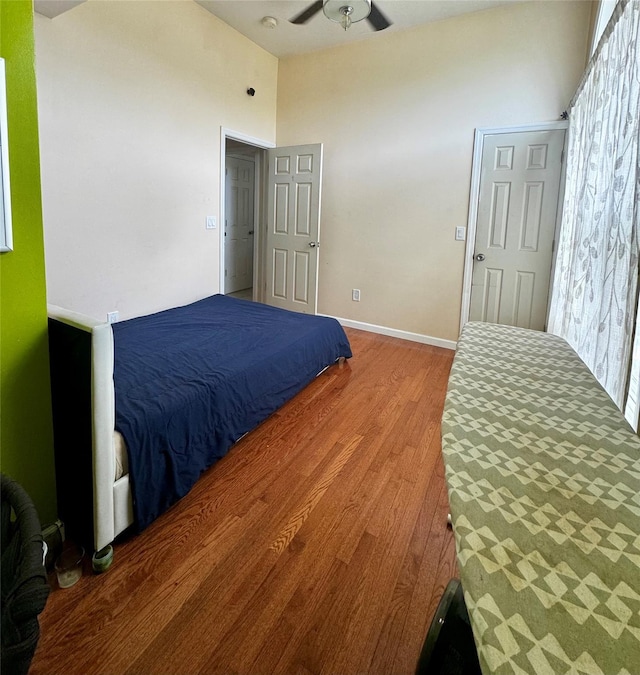 146 Grand Blvd, Brentwood, NY 11717 - bedroom featuring wood finished floors, a towering ceiling, baseboards, and ceiling fan