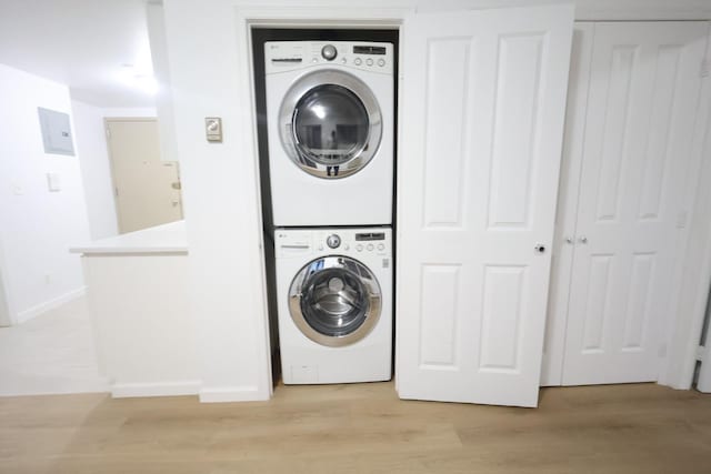 140-37 Cherry Unit 5C, Flushing, NY 11355 - laundry room with stacked washer / dryer, light wood-type flooring, and baseboards