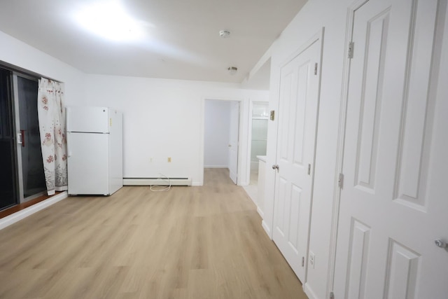 140-37 Cherry Unit 5C, Flushing, NY 11355 - hallway featuring baseboard heating, light wood finished floors, and baseboards