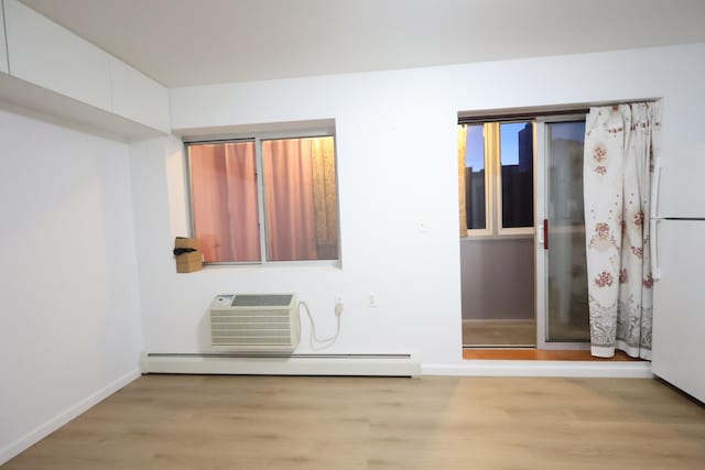 140-37 Cherry Unit 5C, Flushing, NY 11355 - spare room featuring baseboard heating, light wood finished floors, and baseboards