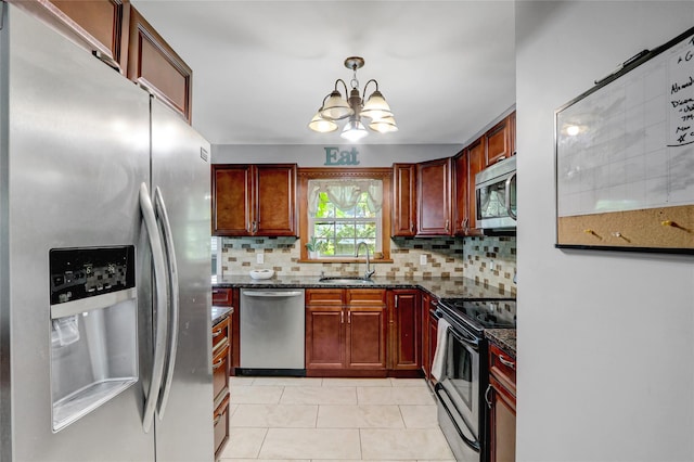 77 N Prospect Ave, Patchogue, NY 11772 - kitchen featuring appliances with stainless steel finishes, a sink, backsplash, a chandelier, and light tile patterned flooring