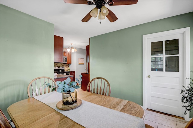 77 N Prospect Ave, Patchogue, NY 11772 - dining area with a ceiling fan, a chandelier, and light tile patterned floors