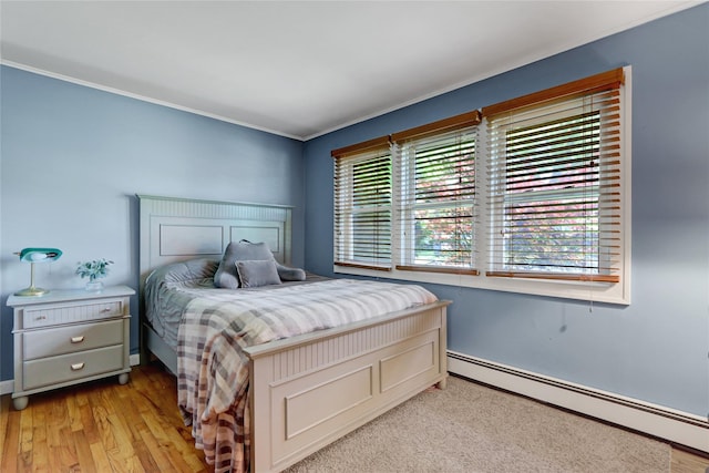 77 N Prospect Ave, Patchogue, NY 11772 - bedroom featuring a baseboard radiator, crown molding, baseboards, and light wood finished floors