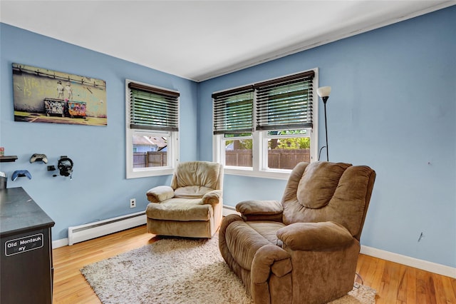 77 N Prospect Ave, Patchogue, NY 11772 - living area featuring baseboard heating, wood finished floors, and baseboards
