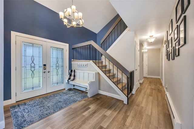 5 Firwood Dr, Farmingville, NY 11738 - entryway with french doors, a chandelier, stairs, wood finished floors, and a baseboard heating unit