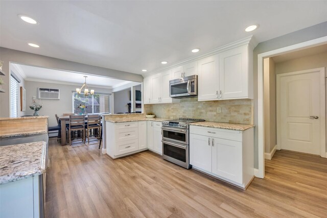 5 Firwood Dr, Farmingville, NY 11738 - kitchen with stainless steel appliances, white cabinetry, a peninsula, light wood-type flooring, and crown molding