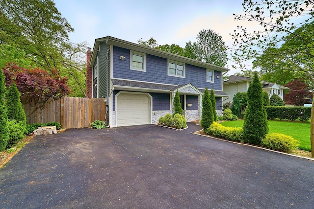 2 Hawthorne St, Farmingdale, NY 11735 - view of front facade with asphalt driveway, stone siding, a chimney, and a garage