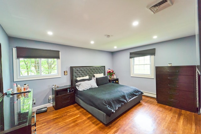 2 Hawthorne St, Farmingdale, NY 11735 - bedroom with wood finished floors, a baseboard radiator, recessed lighting, and baseboards