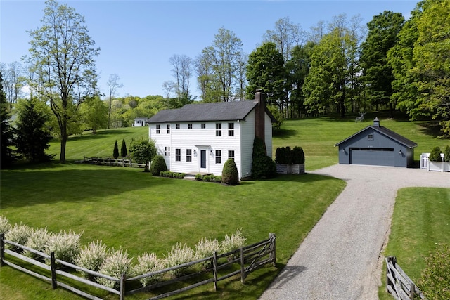 620 Rte 343, Millbrook, NY 12545 - colonial inspired home featuring an outbuilding, a chimney, a detached garage, view of wooded area, and gravel driveway