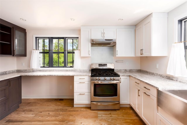 620 Rte 343, Millbrook, NY 12545 - kitchen with stainless steel gas stove, under cabinet range hood, white cabinetry, light wood finished floors, and recessed lighting