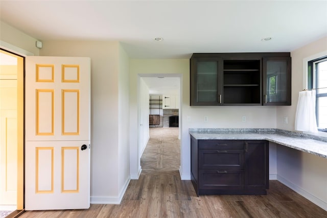 620 Rte 343, Millbrook, NY 12545 - kitchen with wood finished floors, open shelves, baseboards, and light stone counters