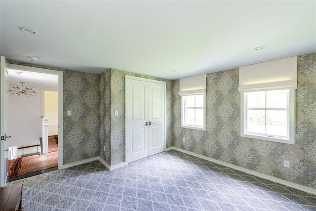 620 Rte 343, Millbrook, NY 12545 - unfurnished bedroom featuring wallpapered walls, baseboards, and a closet