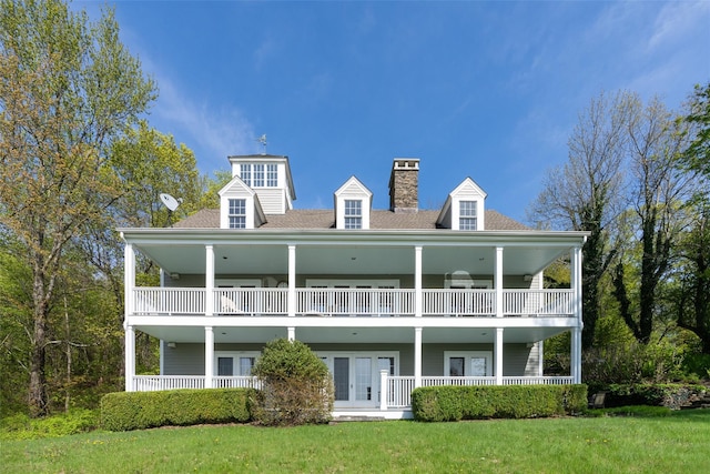 139 Charlie Hill Rd, Millerton, NY 12546 - rear view of house featuring a balcony, a chimney, and a lawn