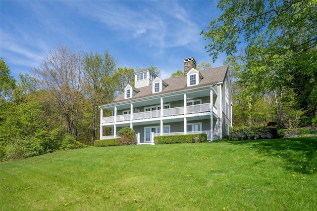 139 Charlie Hill Rd, Millerton, NY 12546 - rear view of house featuring a lawn, a balcony, and a chimney