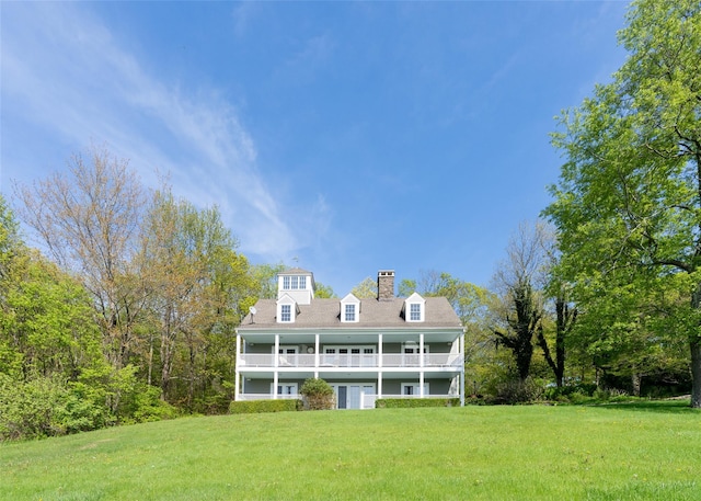 139 Charlie Hill Rd, Millerton, NY 12546 - rear view of house featuring a balcony, a yard, and a chimney