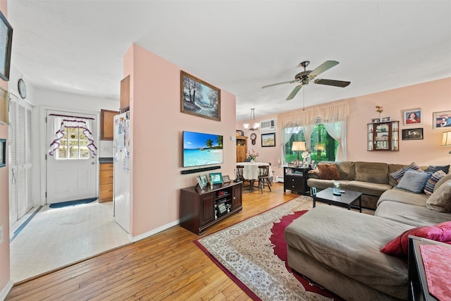 397 Mine Rd, Monroe, NY 10950 - living area with light wood-type flooring, a ceiling fan, a chandelier, baseboards, and a wall mounted AC